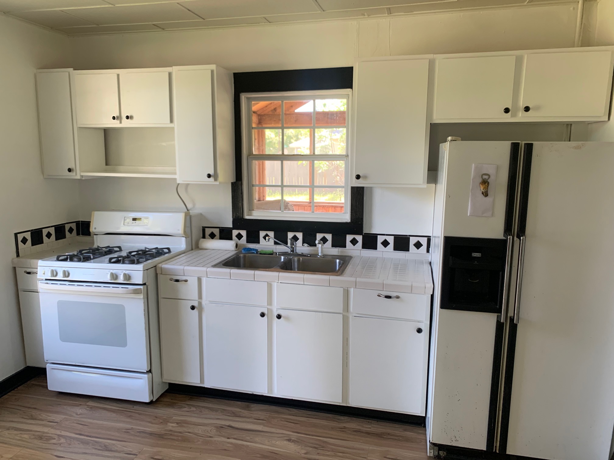 435 North Street Bertram, TX 78605 - Photo 7 of 14 a kitchen with a sink cabinets and wooden floor