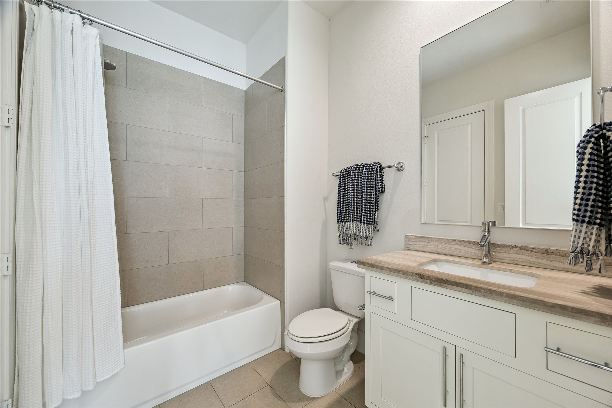 6108 Nicholas Grove Place Houston, TX 77055 - Photo 20 of 29 A thoughtful dual-access bathroom serves both the game room and the bedroom, with separate entrances from each space for added convenience and flexibility.