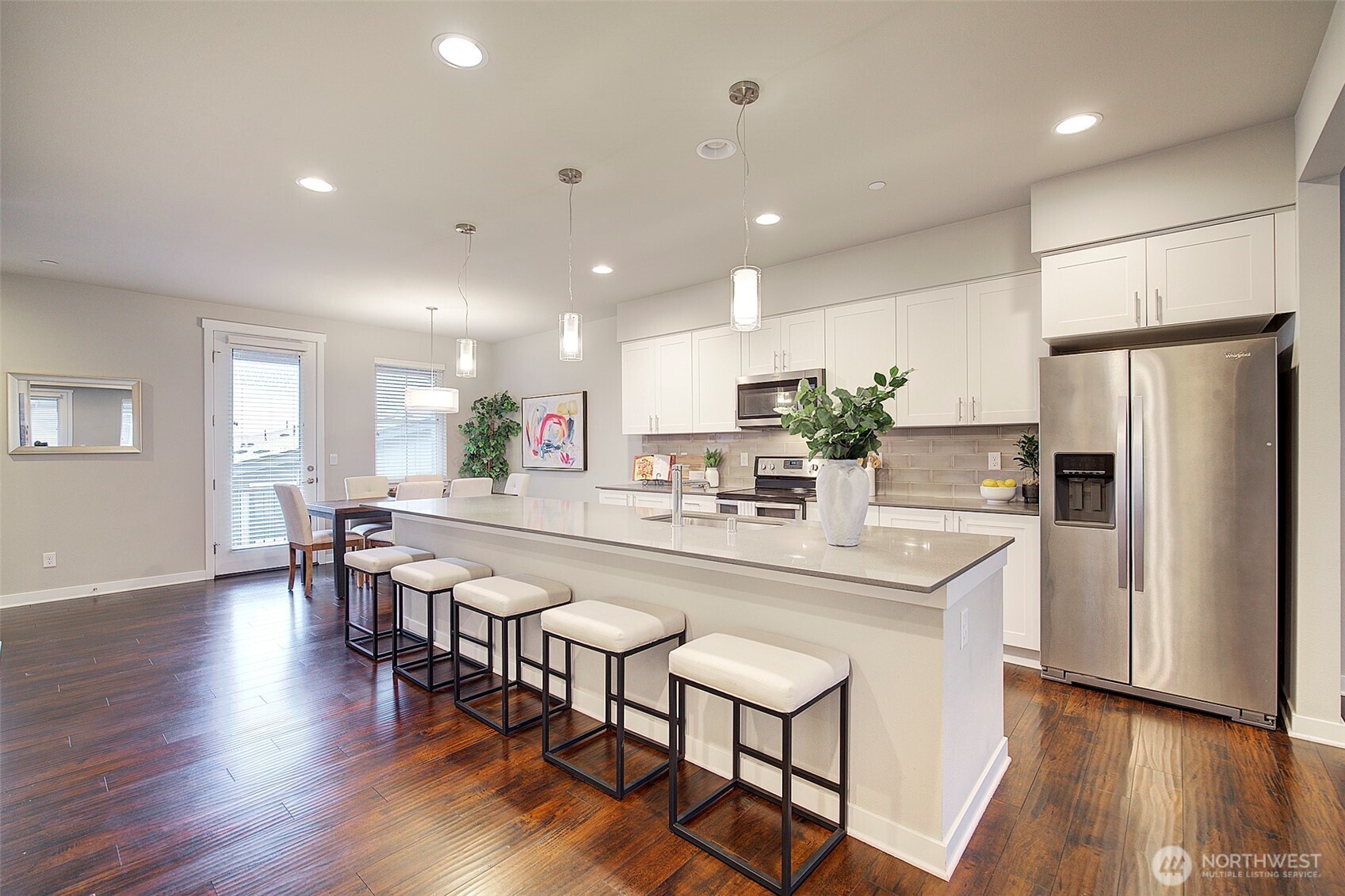 1325 Seattle Hill Road, Unit L2 Bothell, WA 98012 - Photo 13 of 36 a kitchen with stainless steel appliances a dining table chairs refrigerator and microwave