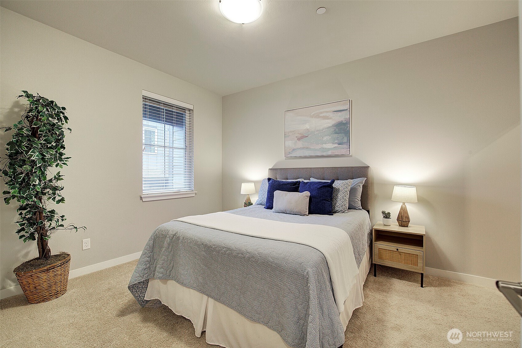 1325 Seattle Hill Road, Unit L2 Bothell, WA 98012 - Photo 5 of 36 a bedroom with a large bed and a potted plant