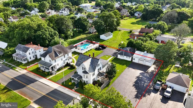 an aerial view of residential house with outdoor space and swimming pool