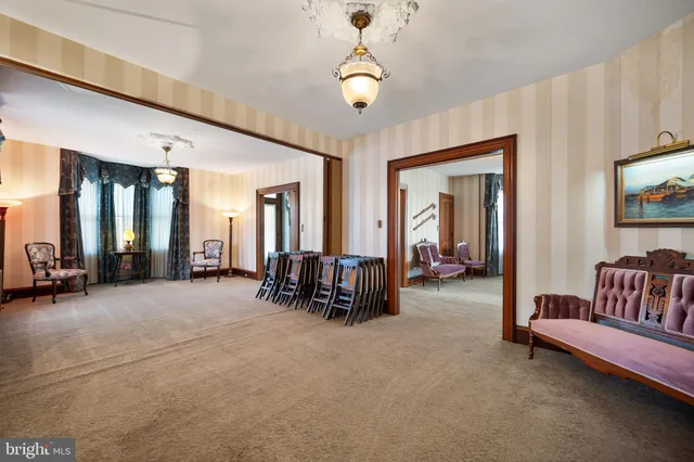 a living room with furniture and a chandelier