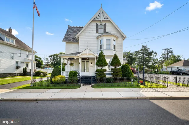 a front view of a house with a garden and plants