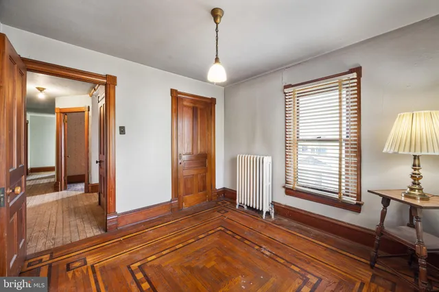 a living room with furniture a window and a chandelier
