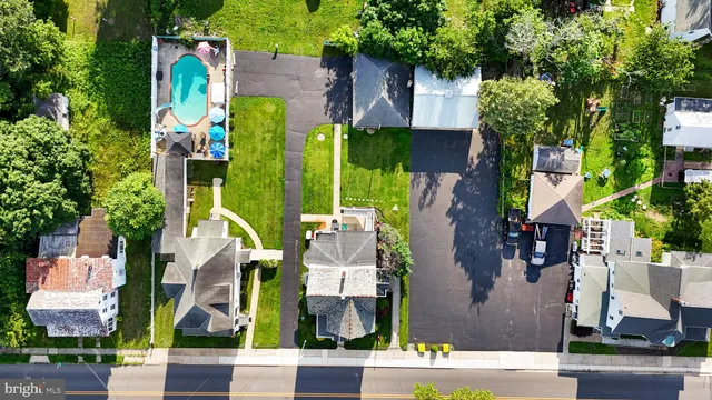 an aerial view of a house with a swimming pool patio and outdoor seating