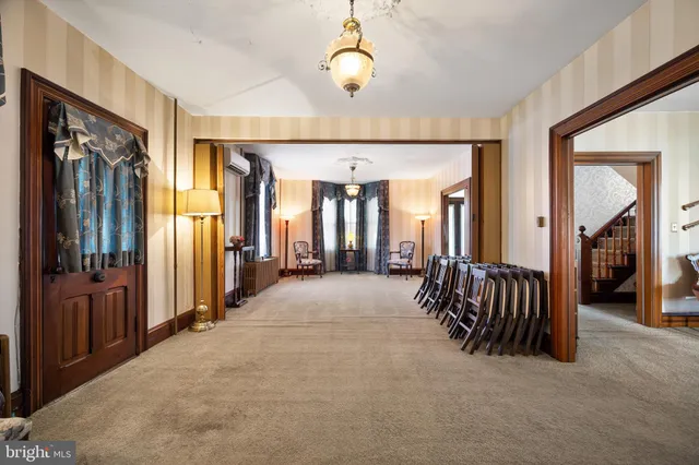 a view of a hallway with closet and stairs