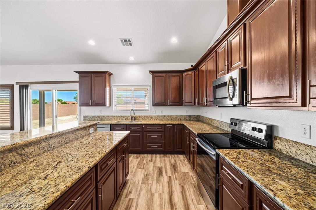 6720 Stubblefield Drive Pahrump, NV 89061 - Photo 16 of 51 Culinary creations come to life in this kitchen, complete with ample counter space and modern appliances.