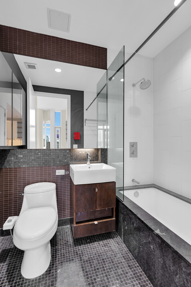 10-17 Jackson Avenue, Unit 2C Queens, NY 11101 - Photo 5 of 6 a bathroom with a sink toilet and shower