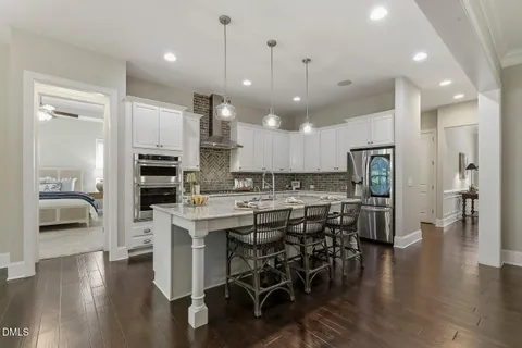 a kitchen with stainless steel appliances kitchen island granite countertop a stove a sink and a microwave