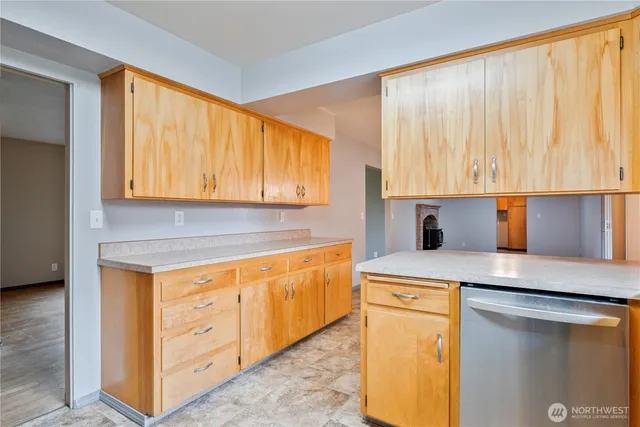 a kitchen with stainless steel appliances granite countertop a sink stove and cabinets