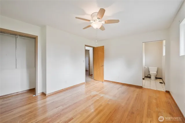 a view of an empty room and wooden floor