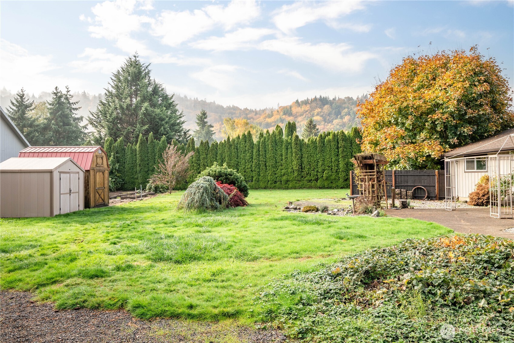 2128 44th Avenue Longview, WA 98632 - Photo 31 of 35 a backyard of a house with table and chairs and a barbeque