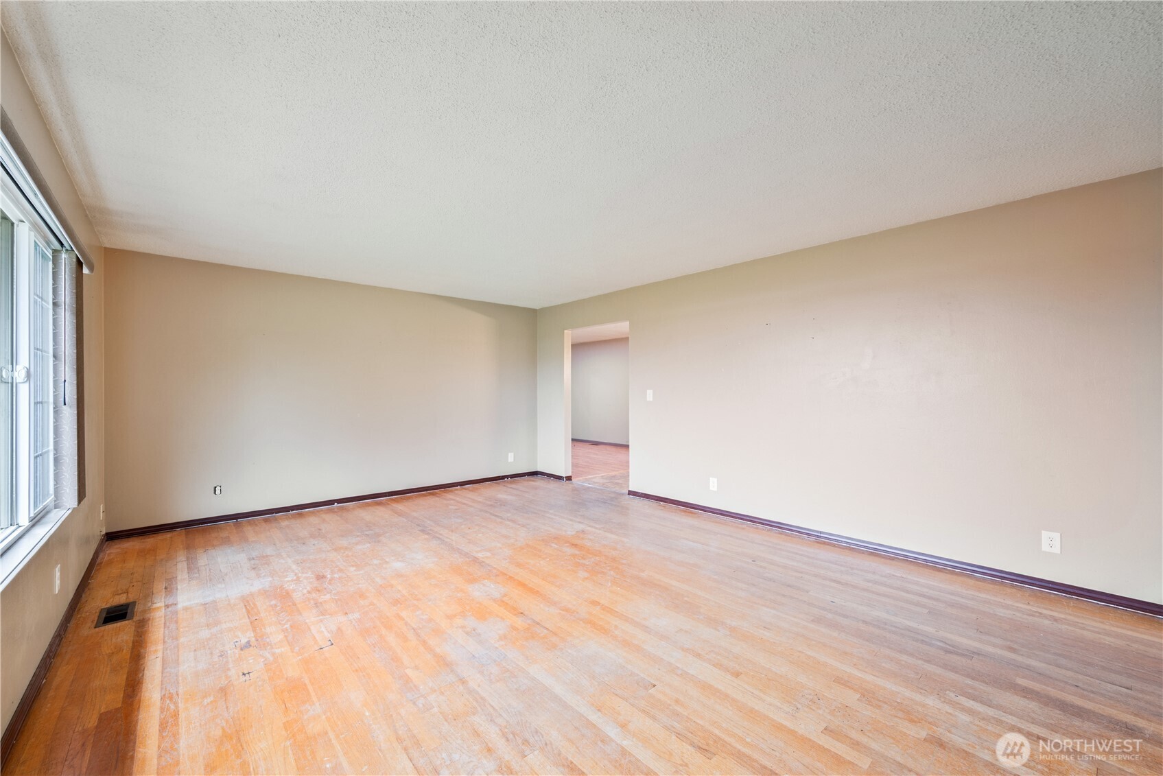 2128 44th Avenue Longview, WA 98632 - Photo 7 of 35 a view of an empty room with wooden floor and a window
