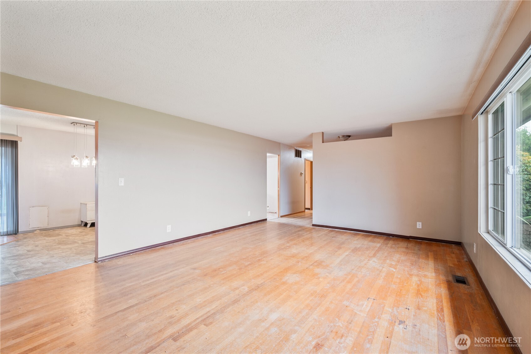 2128 44th Avenue Longview, WA 98632 - Photo 9 of 35 a view of an empty room with wooden floor and a window