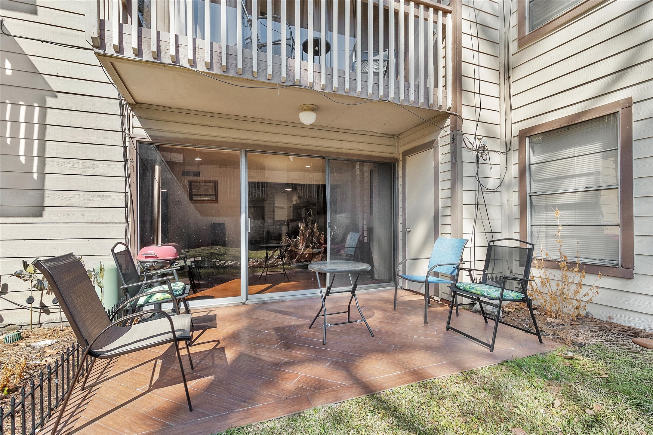 12900 Walden Road, Unit D 411 Montgomery, TX 77356 - Photo 1 of 18 This cozy outdoor patio offers an inviting space for relaxation and entertaining, seamlessly connecting to the interior through sliding glass doors that flood the area with natural light.