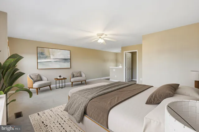 a bedroom with a bed couch and a window