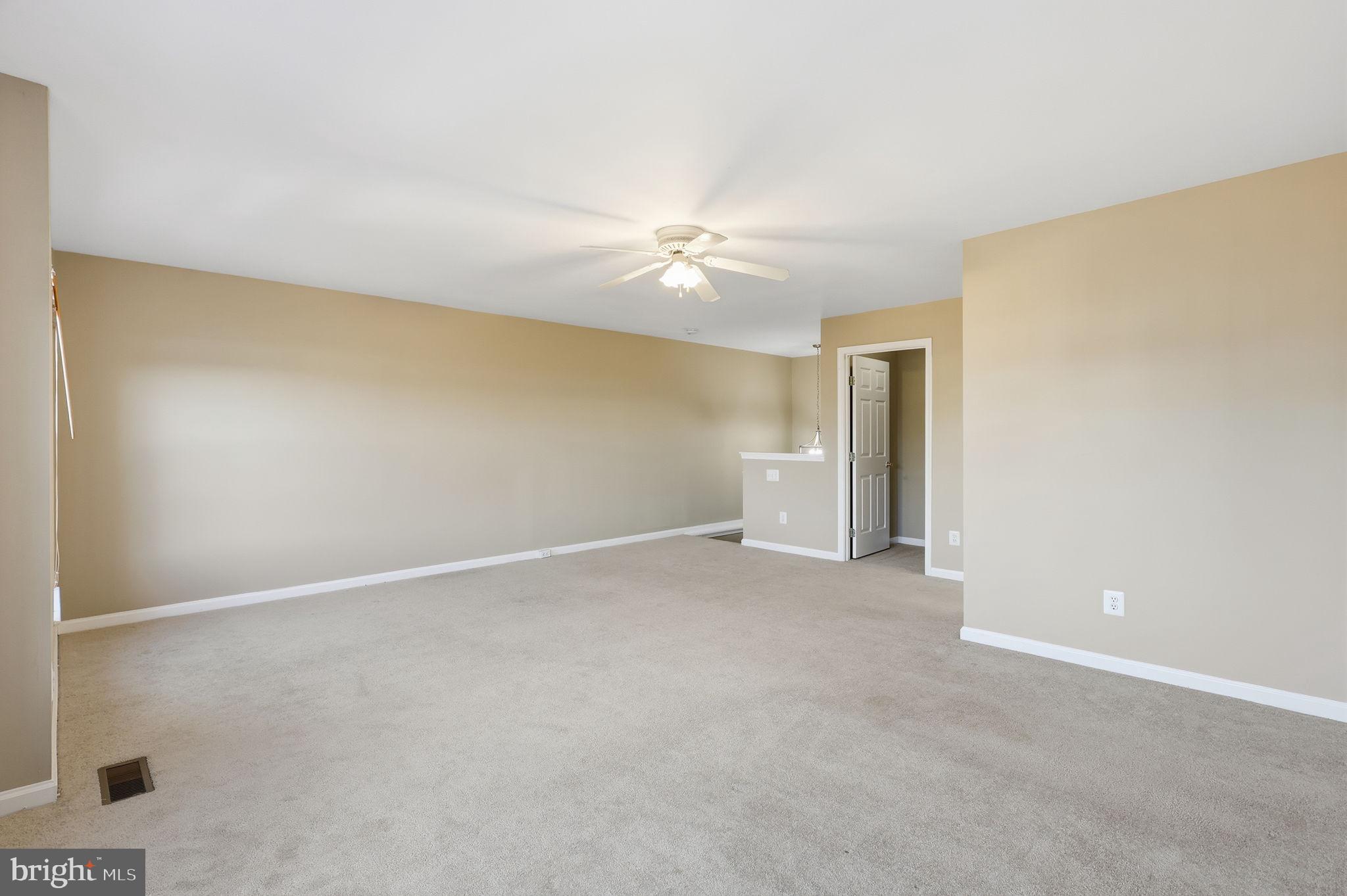 9304 Witch Hazel Way Manassas, VA 20110 - Photo 18 of 45 an empty room with a ceiling fan and a window