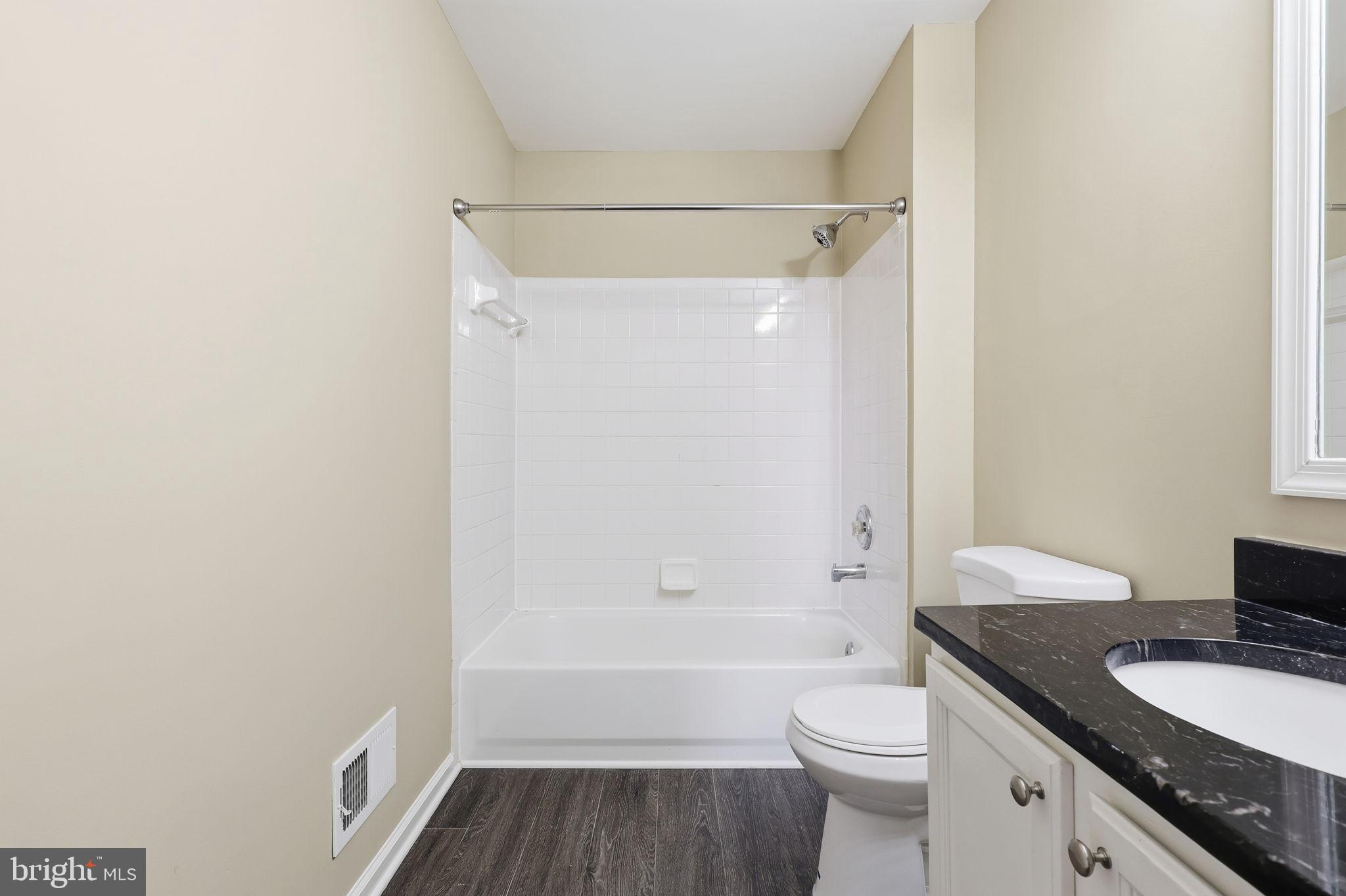9304 Witch Hazel Way Manassas, VA 20110 - Photo 23 of 45 a bathroom with a granite countertop toilet a sink and bathtub