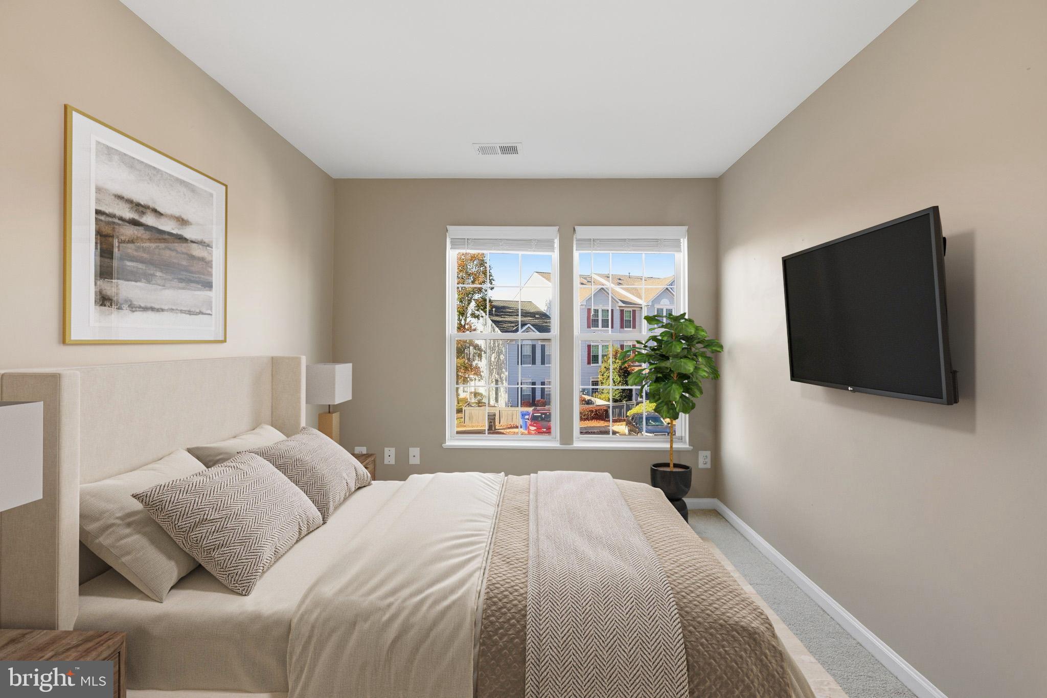 9304 Witch Hazel Way Manassas, VA 20110 - Photo 24 of 45 a bedroom with a bed and a flat screen tv