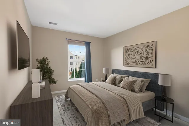 a bedroom with a large bed and a window