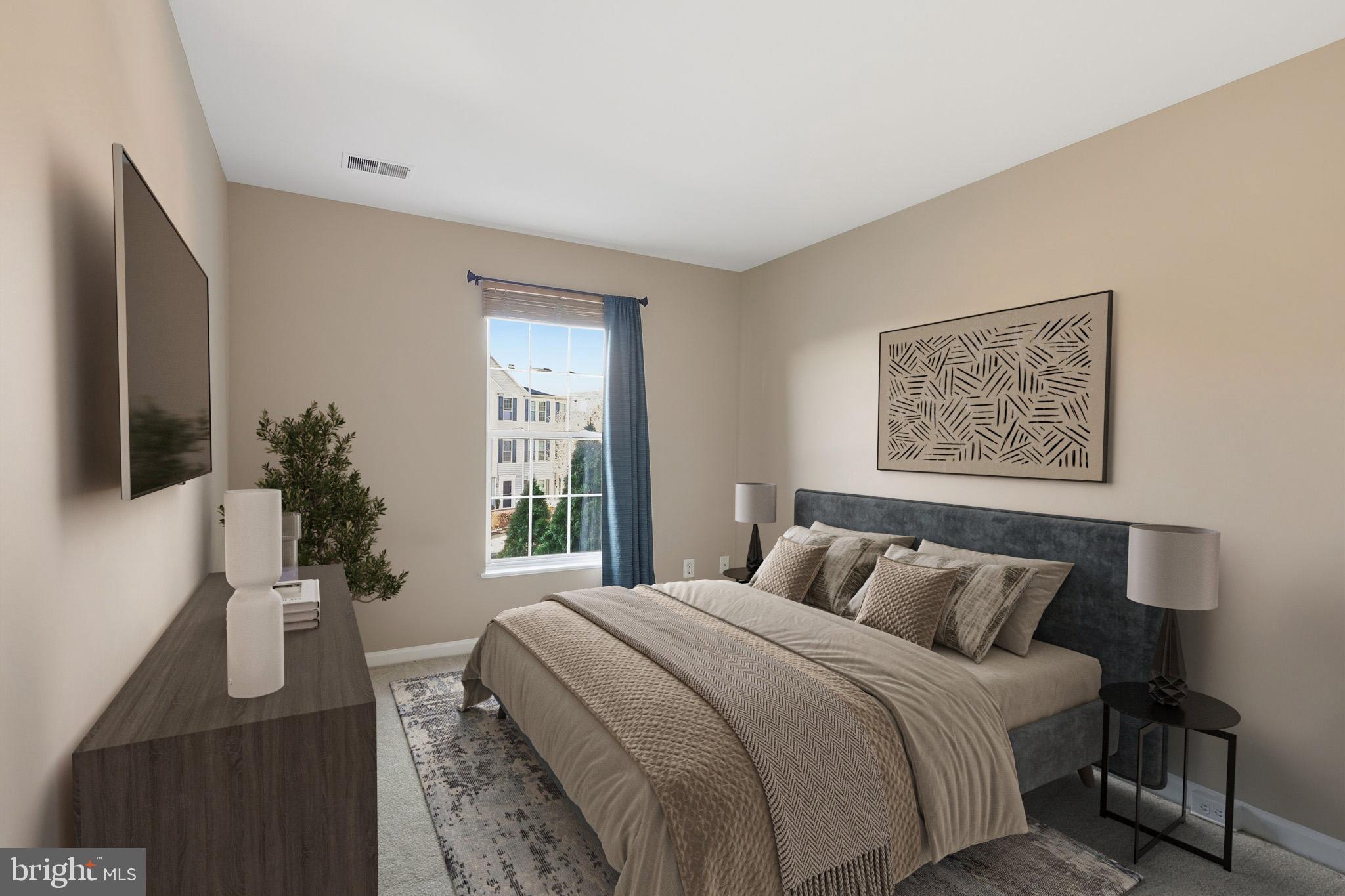 9304 Witch Hazel Way Manassas, VA 20110 - Photo 28 of 45 a bedroom with a large bed and a window