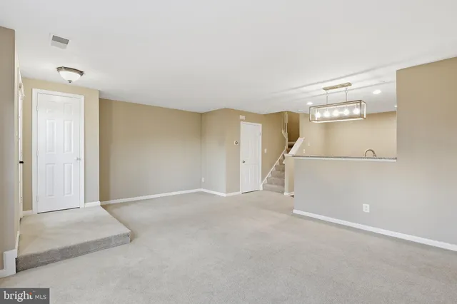 an empty room with windows and entrance