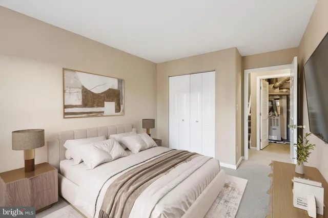 a bedroom with a bed and a painting on the wall