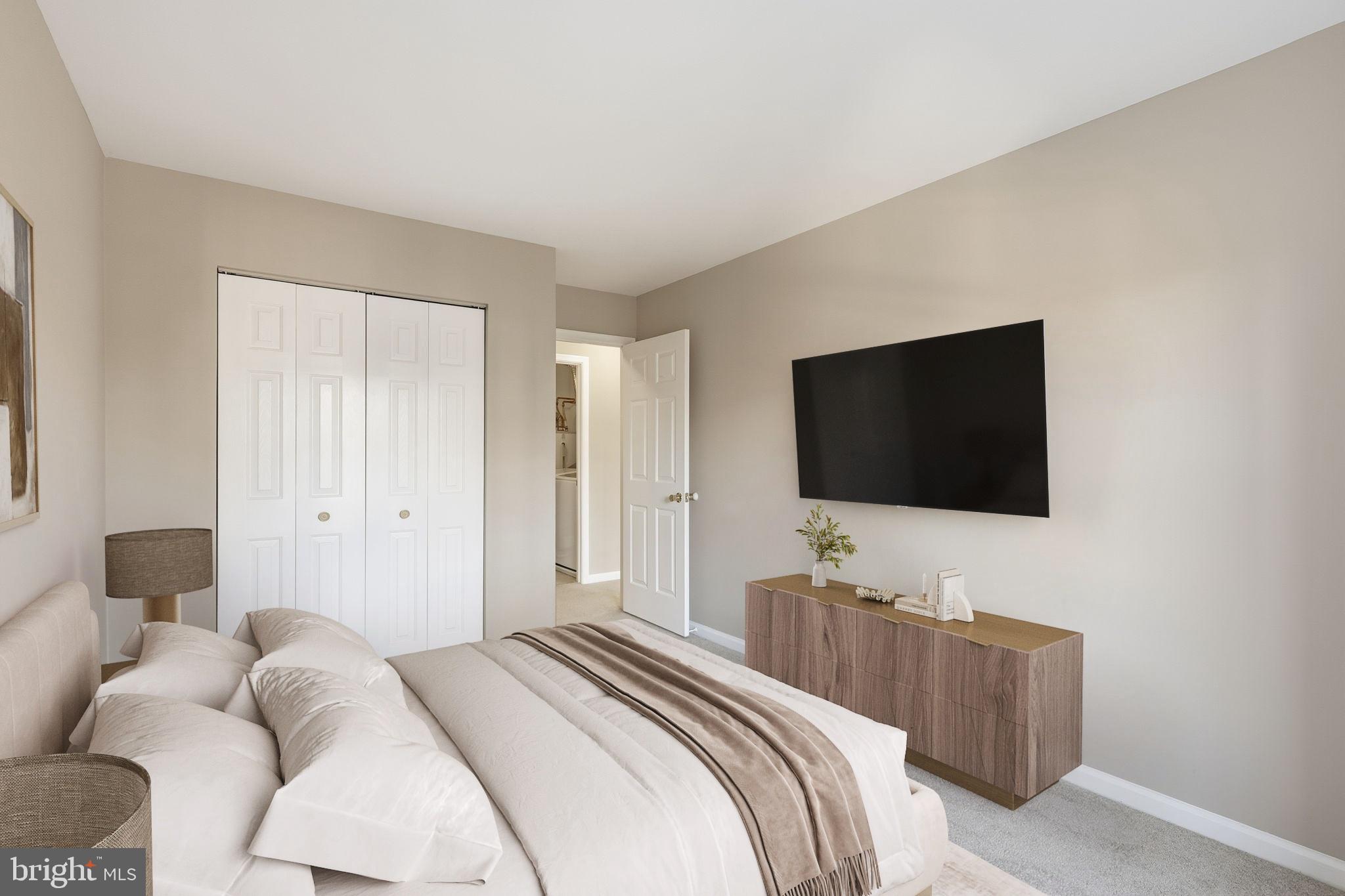 9304 Witch Hazel Way Manassas, VA 20110 - Photo 36 of 45 a bedroom with a bed and a flat screen tv