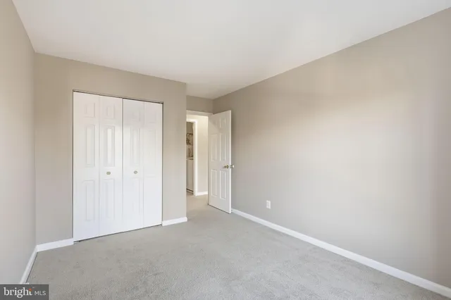 a view of an empty room and closet area