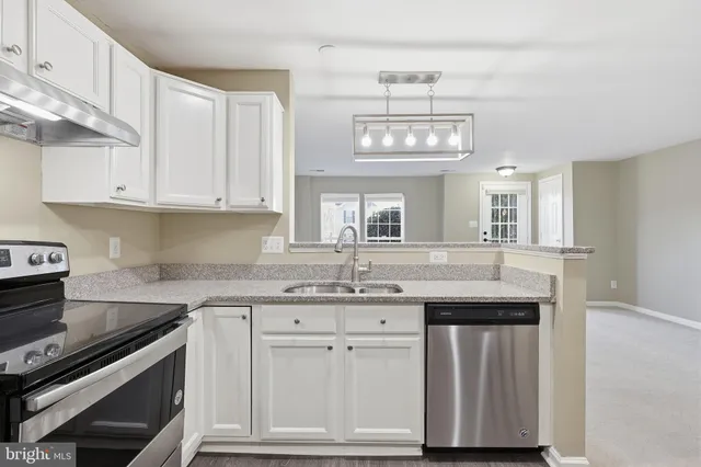 a kitchen with stainless steel appliances granite countertop a sink and cabinets