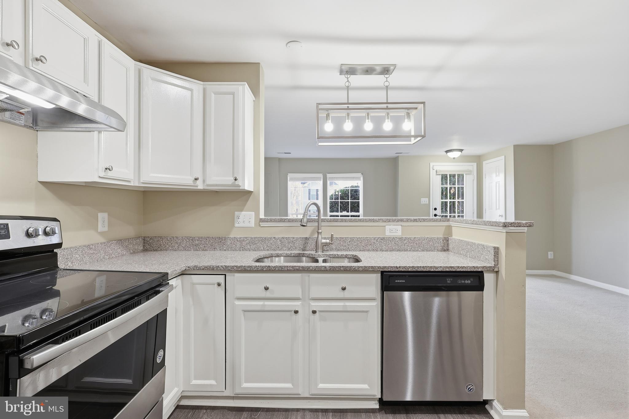 9304 Witch Hazel Way Manassas, VA 20110 - Photo 9 of 45 a kitchen with stainless steel appliances granite countertop a sink and cabinets