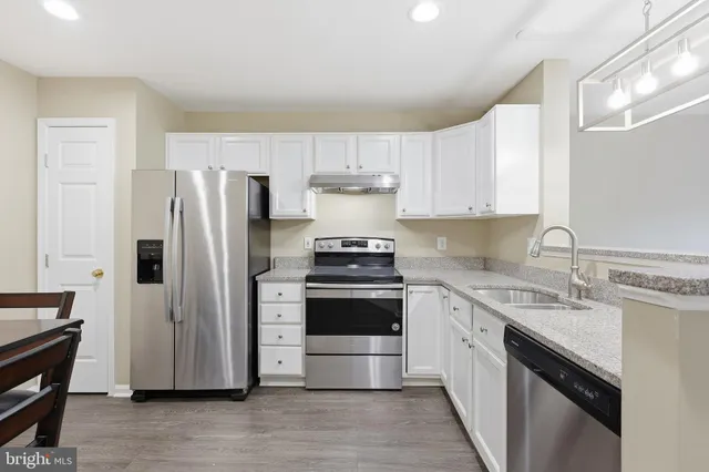 a kitchen with a stove sink and refrigerator