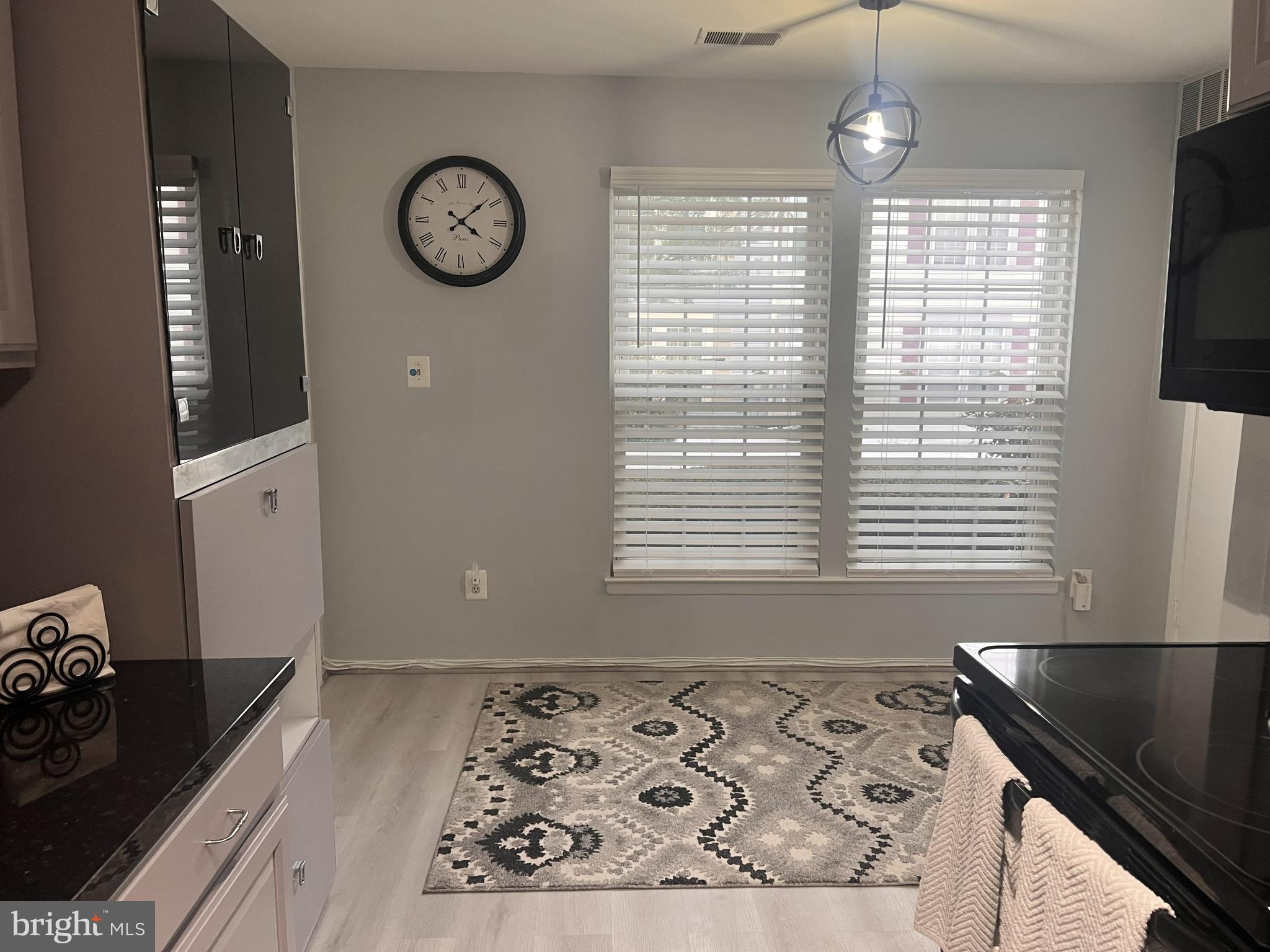 3142 Quartet Lane, Unit 255 Silver Spring, MD 20904 - Photo 12 of 14 a view of a kitchen with wooden floor and a window