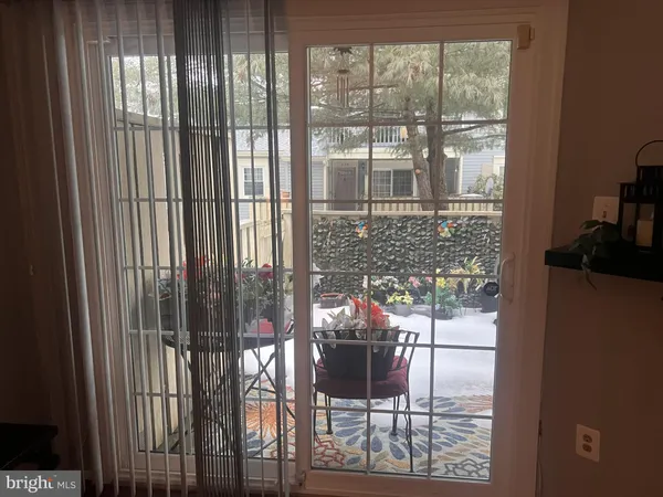 a dining room with furniture and floor to ceiling window