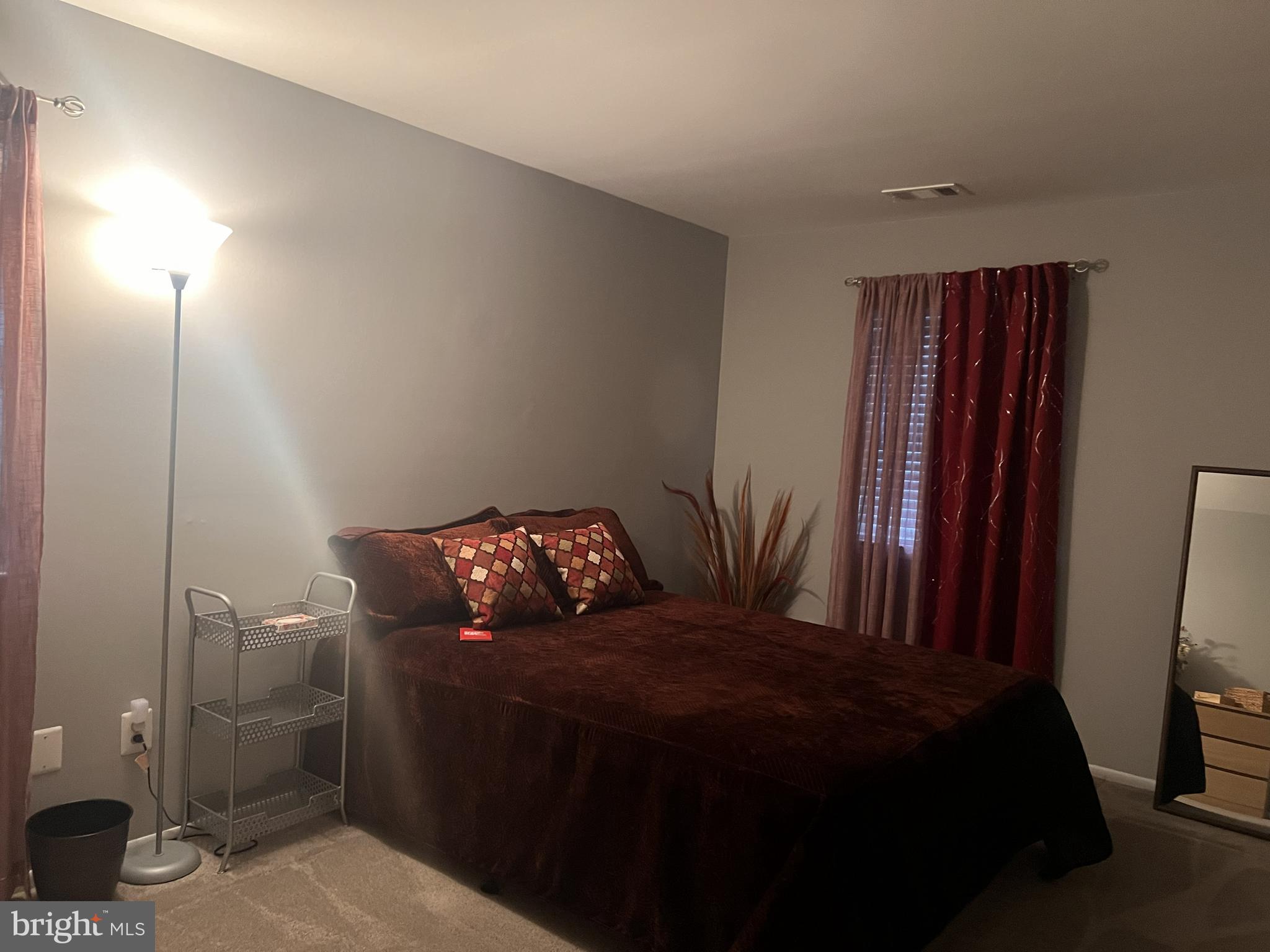 3142 Quartet Lane, Unit 255 Silver Spring, MD 20904 - Photo 6 of 14 a bedroom with a bed and a mirror