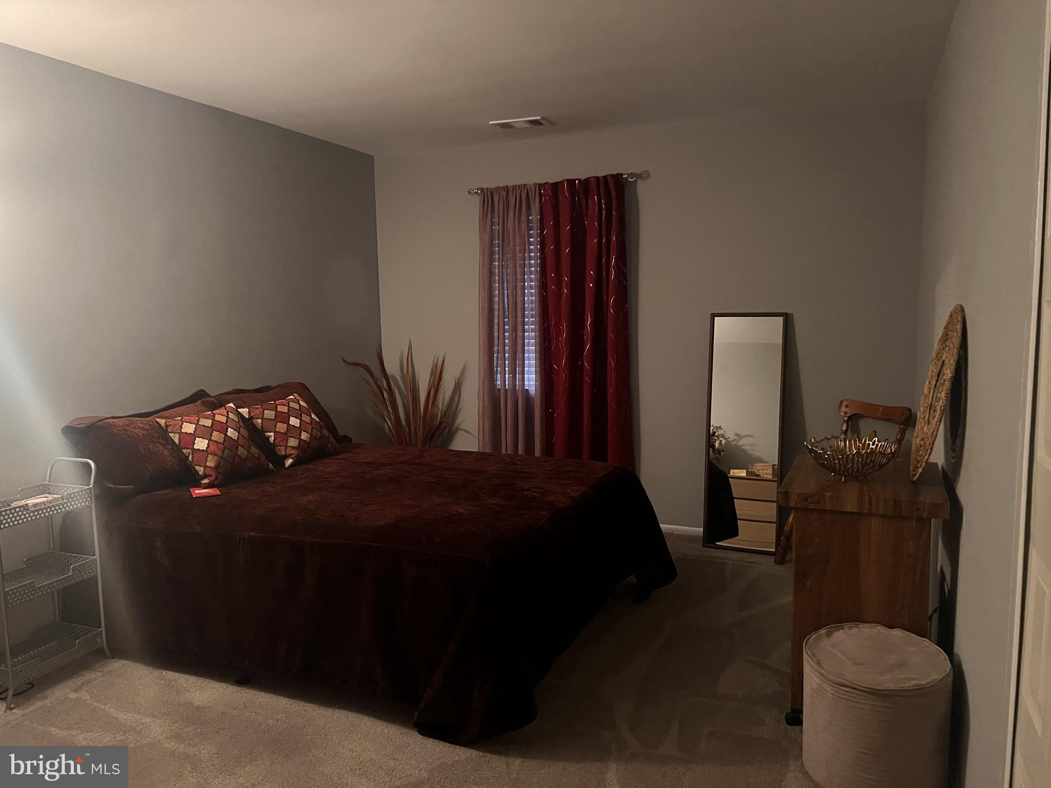 3142 Quartet Lane, Unit 255 Silver Spring, MD 20904 - Photo 7 of 14 a bedroom with a bed and a potted plant