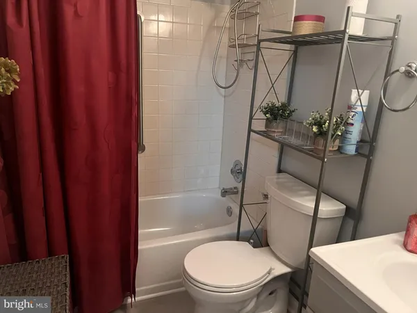 a white toilet sitting next to a bath tub and shower