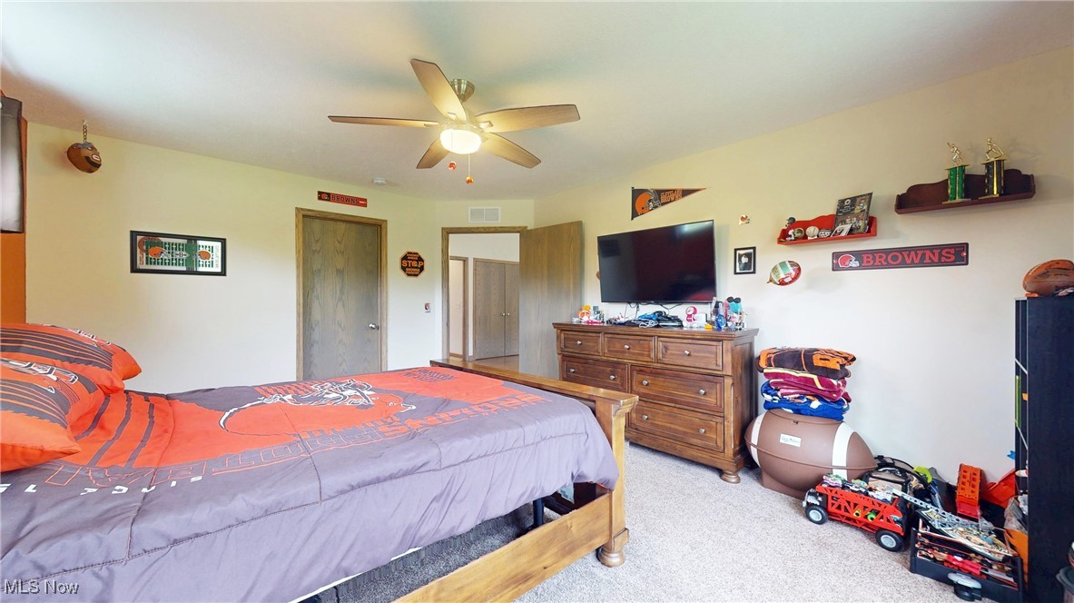 961 Industry Road Atwater, OH 44201 - Photo 22 of 50 Bedroom with light carpet and ceiling fan
