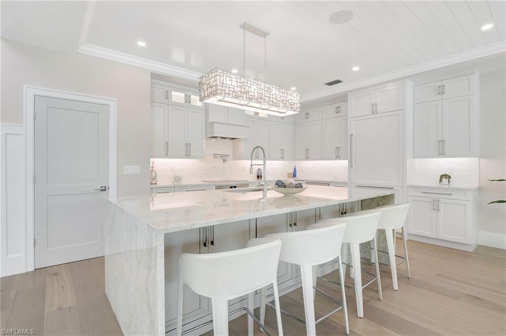 1308 Ridge Street Naples, FL 34103 - Photo 20 of 48 a kitchen with a center island and cabinets