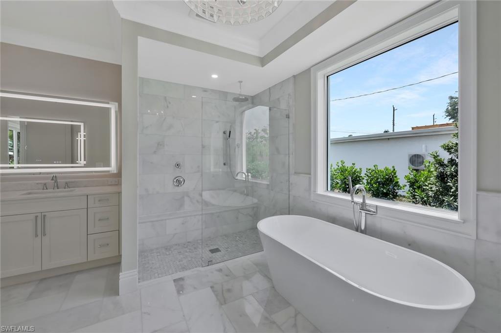 1308 Ridge Street Naples, FL 34103 - Photo 28 of 48 a bathroom with a tub a sink and a shower