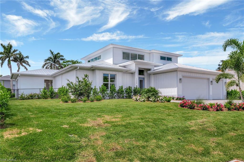 1308 Ridge Street Naples, FL 34103 - Photo 44 of 48 a front view of a house with garden