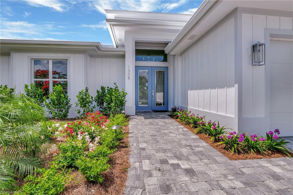 1308 Ridge Street Naples, FL 34103 - Photo 6 of 48 Front Entry Door with Colorful Plantings