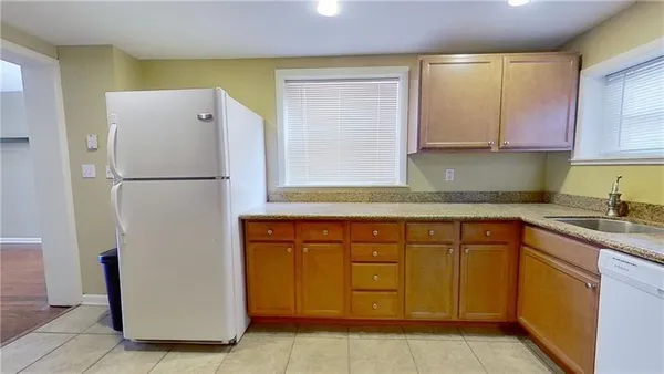 a white refrigerator freezer sitting in a kitchen