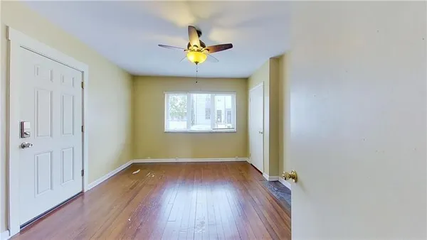 wooden floor in an empty room with a window