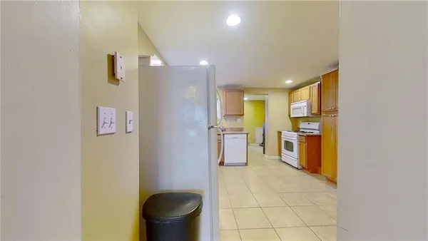 a view of a kitchen with furniture and stainless steel appliances