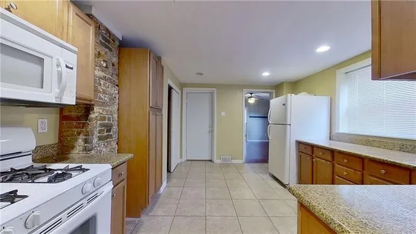 a kitchen with refrigerator cabinets and a stove