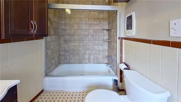 a bathroom with a bath tub and shower