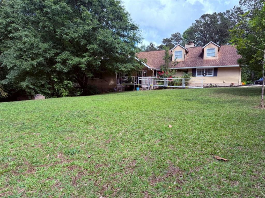 1972 Mt Zion Road Oxford, GA 30054 - Photo 1 of 15 a view of a big yard with table and chairs under an umbrella