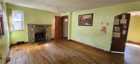 a room with a fireplace and wooden floor