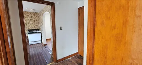 a kitchen with stainless steel appliances wooden floor and a window